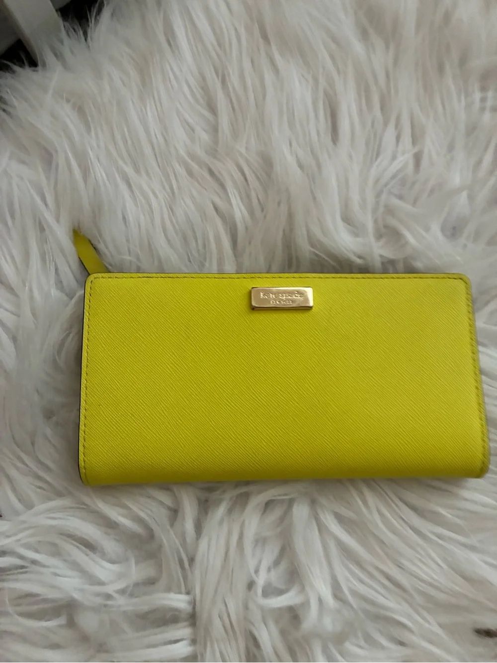 Lime green Kate Spade New York slim bifold wallet features multiple card slots